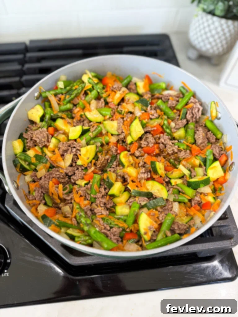 Weeknight Ground Beef Stir Fry 2 Adding perfectly seasoned ground beef to vibrant stir-fry vegetables