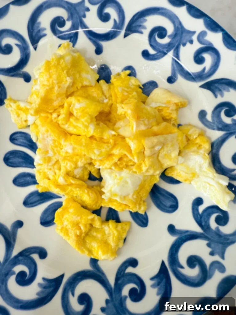 Quick and Delicious Ham Fried Rice 4 Scrambled eggs cooking in a pan