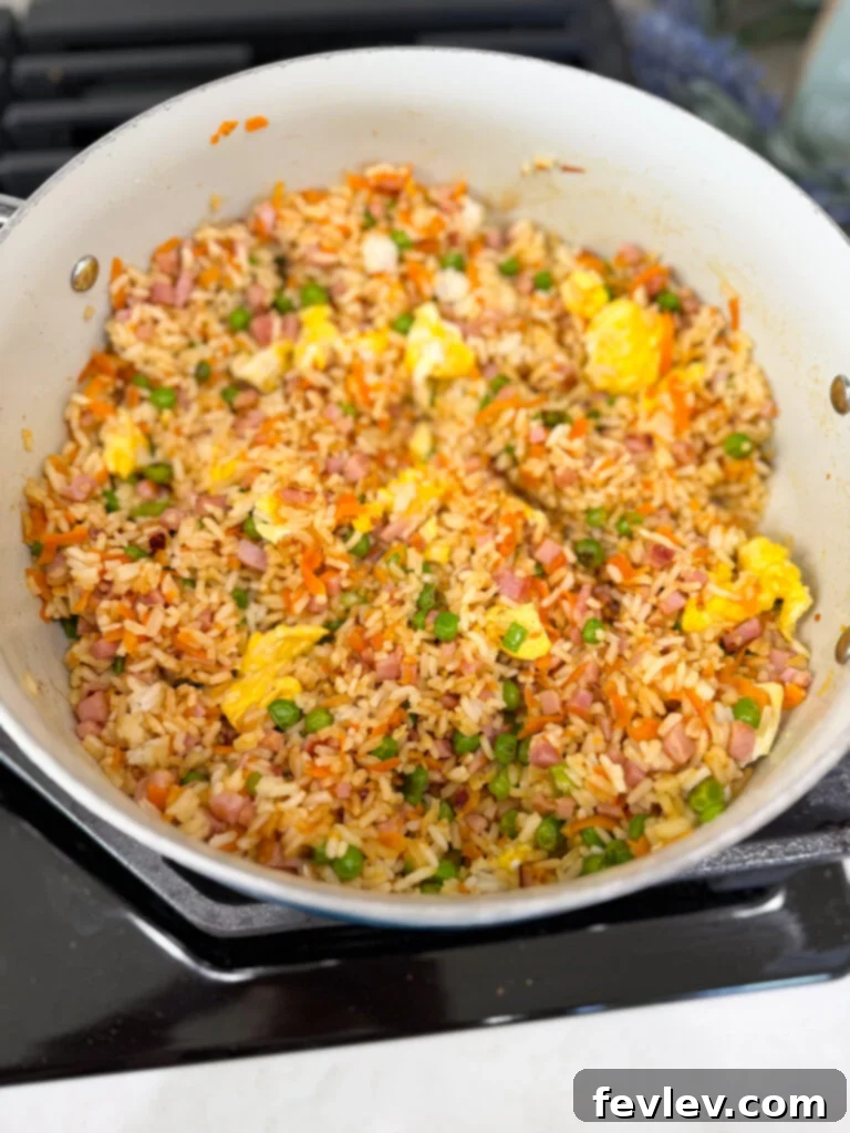 Quick and Delicious Ham Fried Rice 8 Mixing fried rice with vegetables and eggs