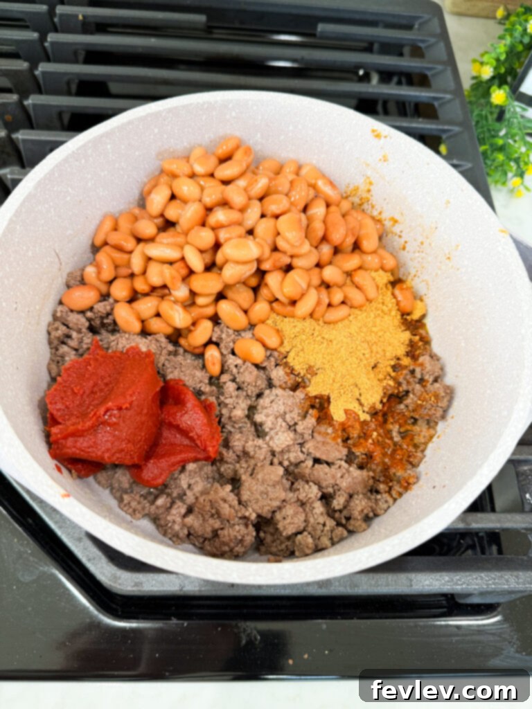 Speedy Savory Beef Tacos 4 add beans and tomato paste to meat