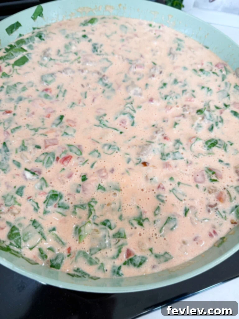 Creamy sauce for pasta simmering in the skillet