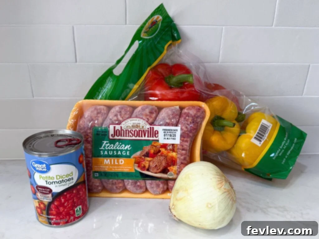 Easy One-Pan Sausage and Peppers 4 Ingredients for One Pot Sausage and Peppers displayed on a cutting board.