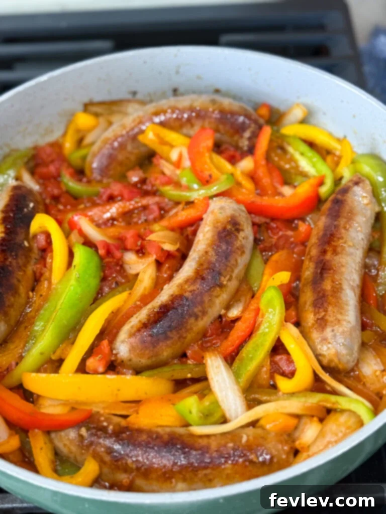 Easy One-Pan Sausage and Peppers 8 Add sausages back to the pan with simmering vegetables and sauce.