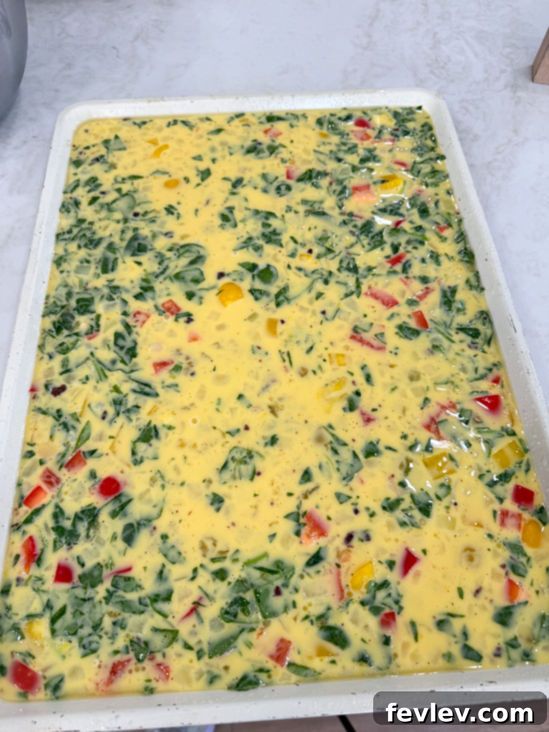 Effortless Breakfast Meal Prep 3 A sheet pan filled with perfectly cooked scrambled eggs, ready for breakfast sandwiches.