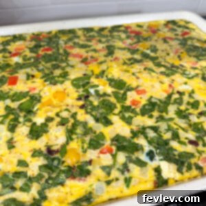 Golden sheet pan eggs for breakfast sandwiches, neatly cut into squares.