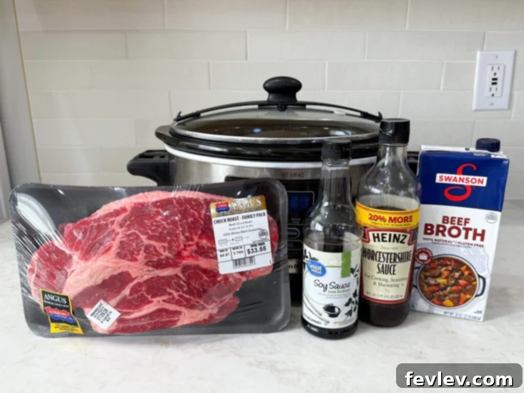 Large slow cooker filled with a raw beef roast, beef broth, and soy sauce, showcasing the initial ingredients before cooking.