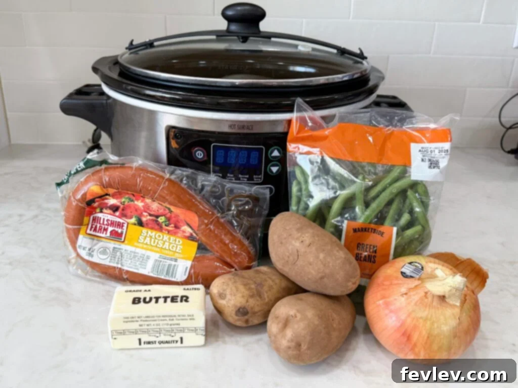 Hearty Slow Cooker Kielbasa with Potatoes and Green Beans 4 Large black and grey slow cooker with sausage, green beans, onion, butter, and potatoes on a white counter, ready for cooking.