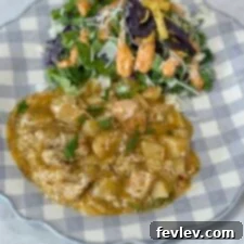 Chicken and potatoes on a blue and white plate with salad