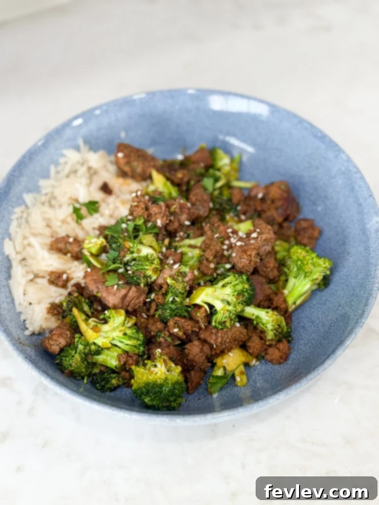 Easy Ground Turkey Hacks 3 A vibrant Sweet & Spicy Turkey and Broccoli Bowl, cooked to perfection and served in a striking blue bowl on a crisp white counter, showcasing a healthy and flavorful meal.