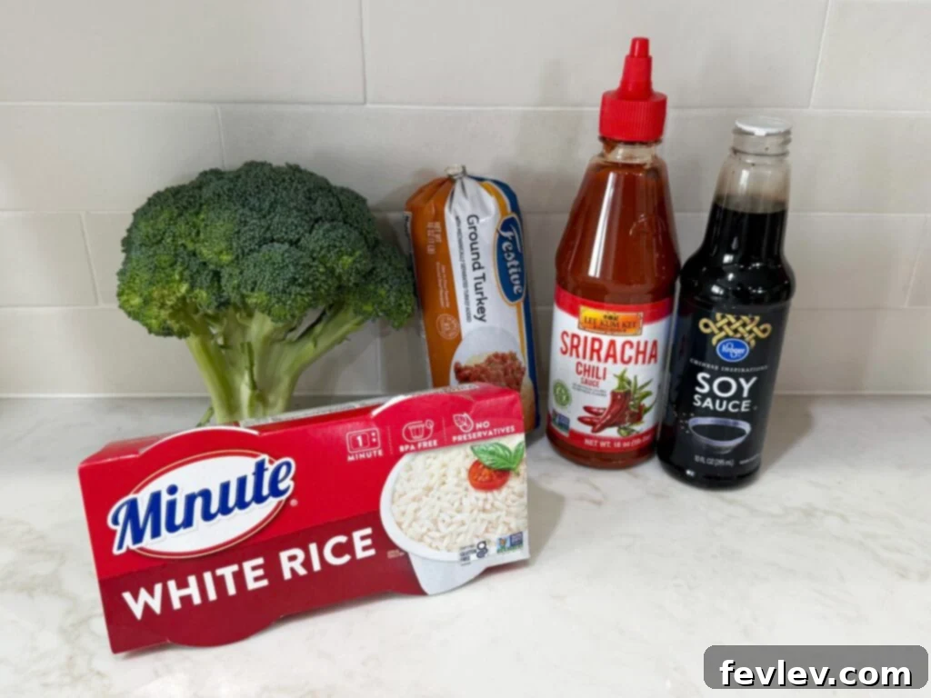 Easy Ground Turkey Hacks 4 Fresh ingredients meticulously arranged on a clean white counter for a Sweet & Spicy Turkey and Broccoli Bowl, featuring lean ground turkey, vibrant broccoli florets, and a box of quick-cook white rice, highlighting preparation simplicity.