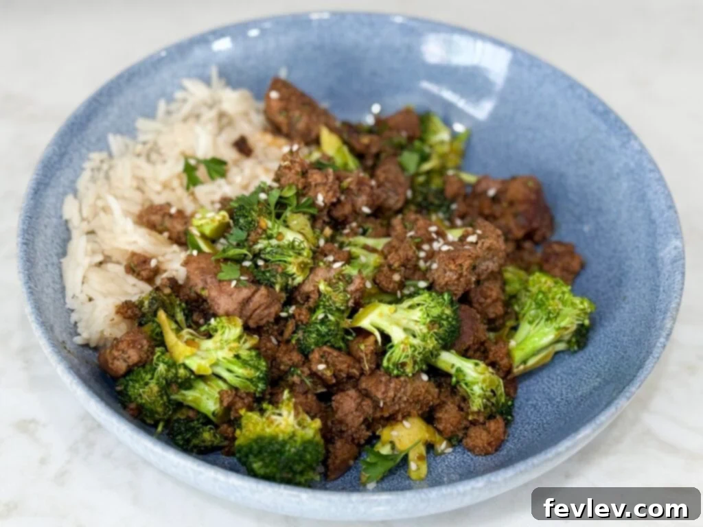 Easy Ground Turkey Hacks 6 A beautifully composed Sweet & Spicy Turkey and Broccoli Bowl, expertly cooked and presented in a vivid blue bowl on a pristine white counter, inviting you to enjoy a healthy and flavorful meal.