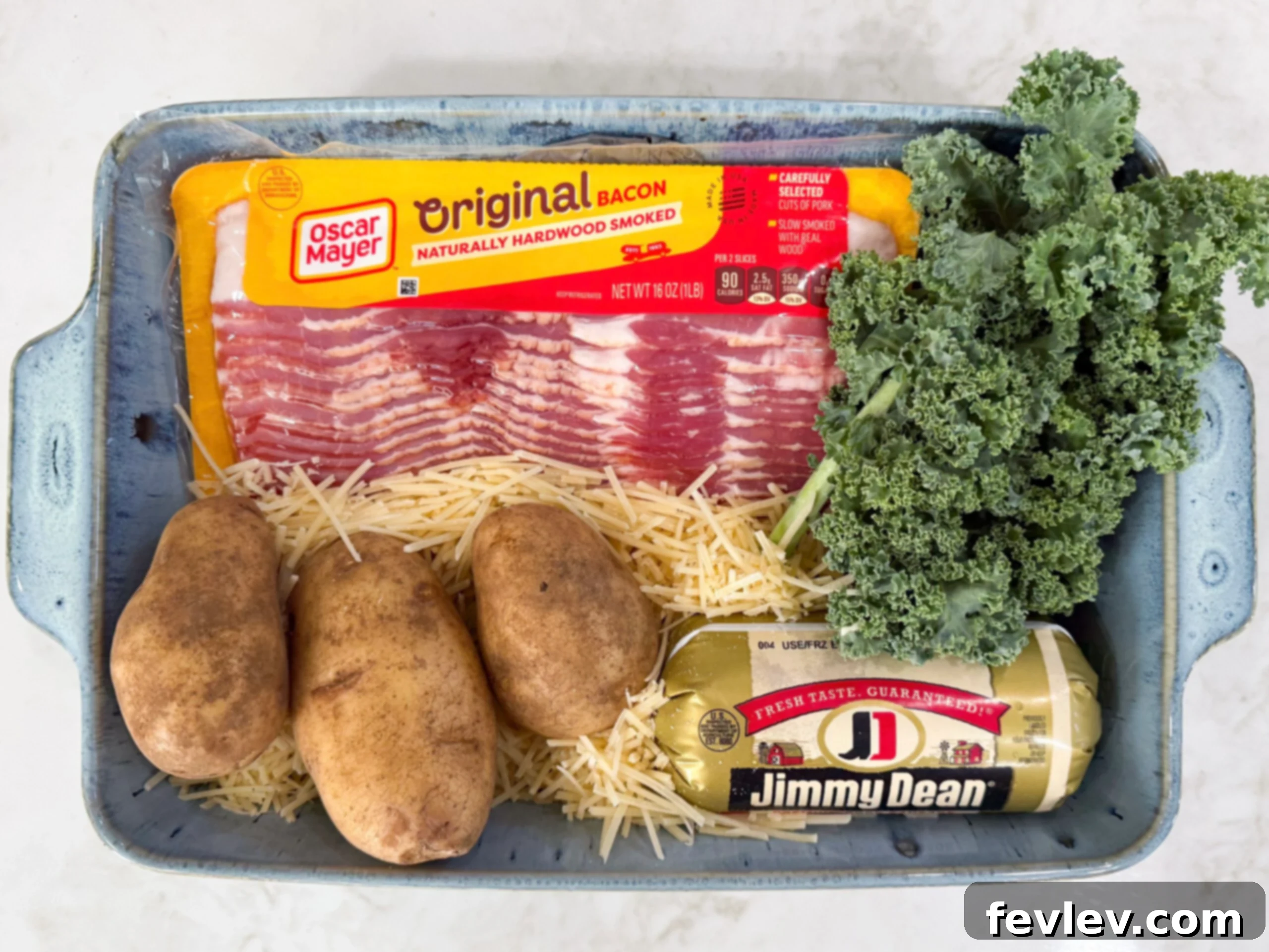 Creamy Tuscan Sausage Potato Kale Casserole 4 Ingredients for Zuppa Toscana Casserole including potatoes, kale, Italian sausage, bacon, onion, cream, broth, and Parmesan cheese.