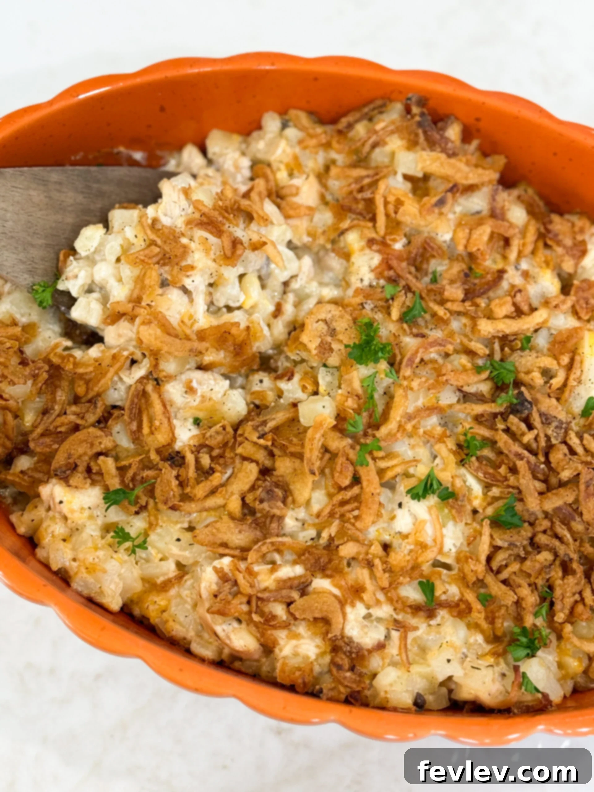 The finished French Onion Chicken Potato Casserole, baked to a golden brown perfection in a 9x13 inch dish, with a generous, crispy layer of French fried onions on top.