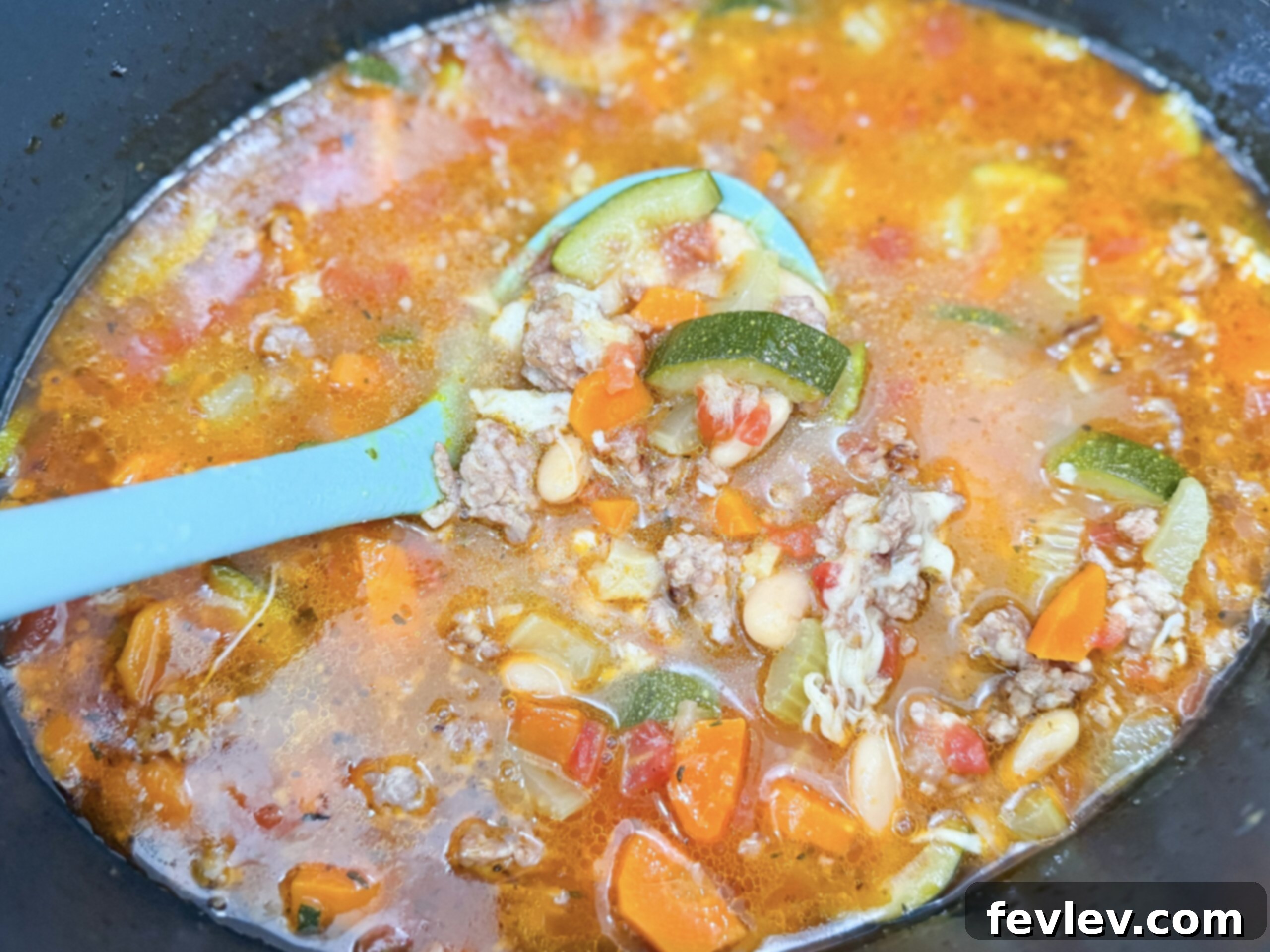 Tuscan Slow Cooker Sausage and Vegetable Soup 6 The fully cooked Slow Cooker Italian Vegetable and Sausage Soup simmering warmly in the crockpot, with vibrant vegetables and rich broth, indicating it's perfectly tender and ready for the final touch.
