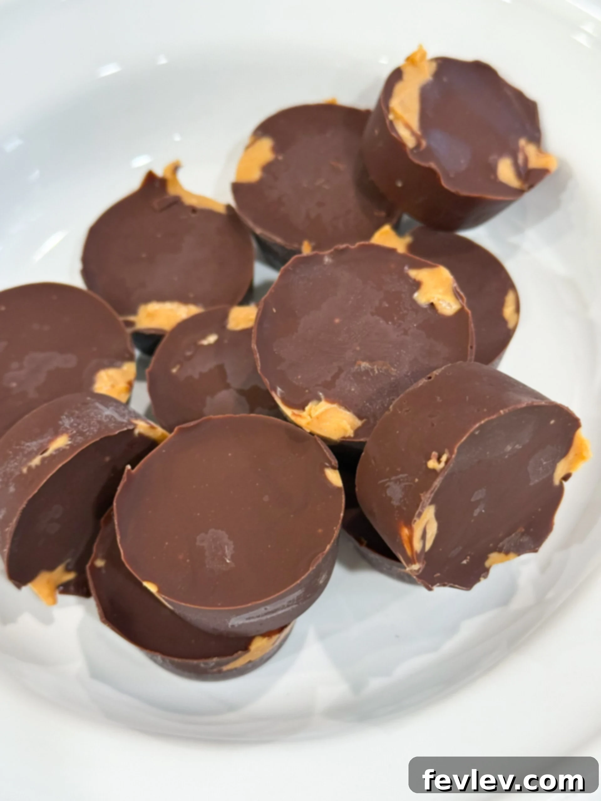 Homemade chocolate peanut butter cups beautifully presented in mini cupcake liners, highlighting their rich chocolate and creamy peanut butter layers.