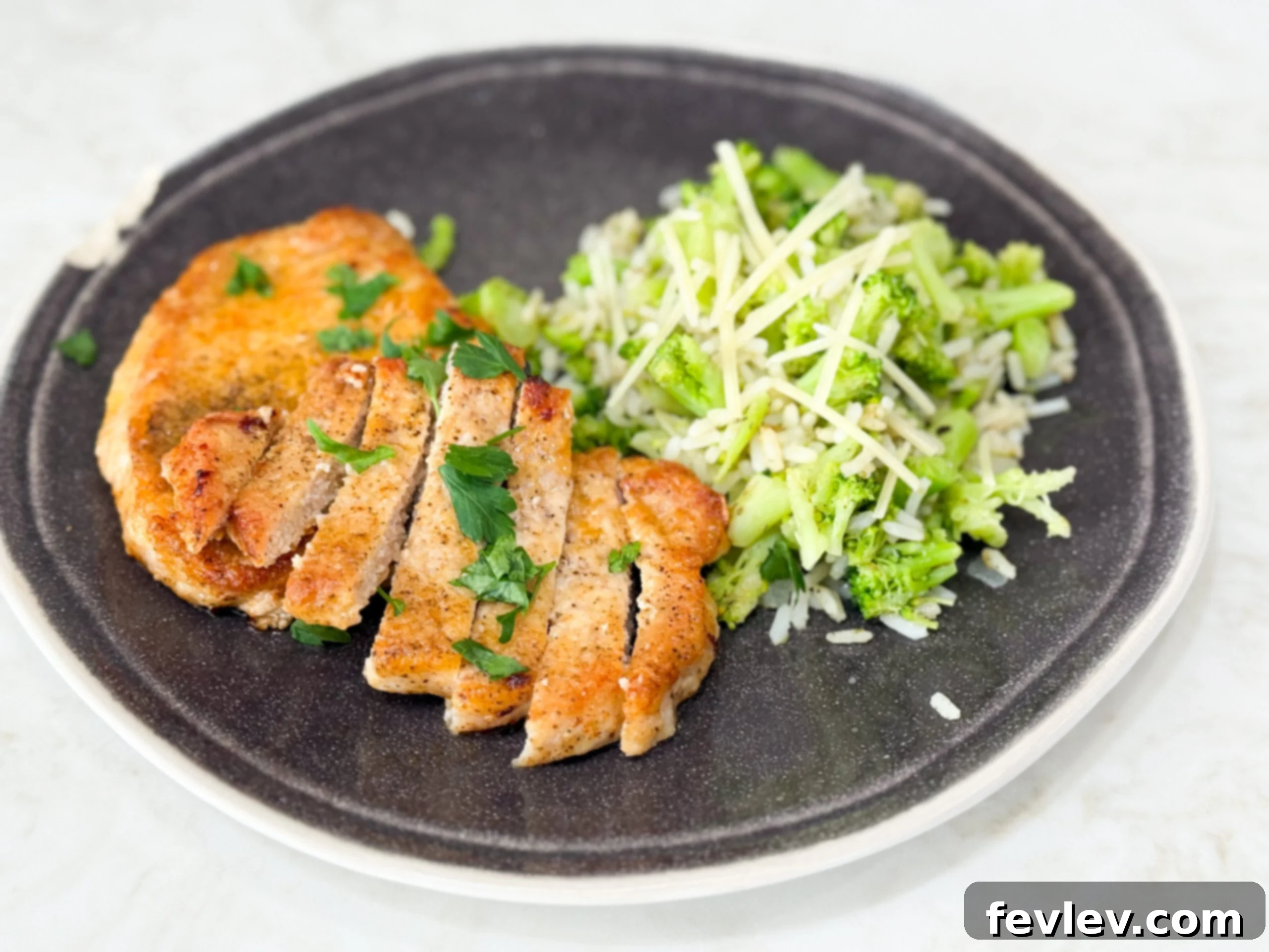 Close-up of golden and crispy pan-fried pork chops, perfectly seared in a skillet, ready to be served.