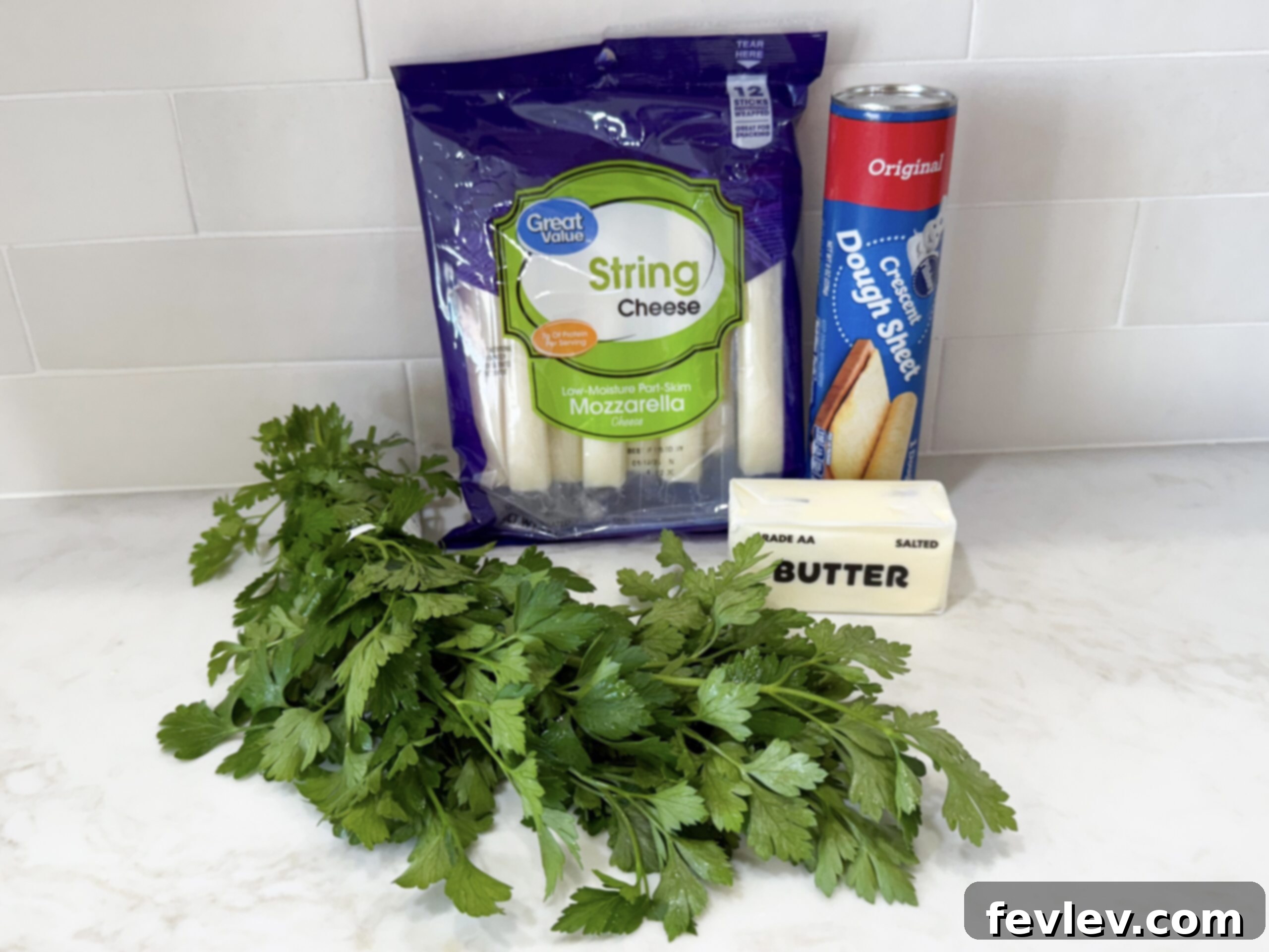 Ingredients for mozzarella-stuffed garlic breadsticks laid out on a counter for easy preparation.