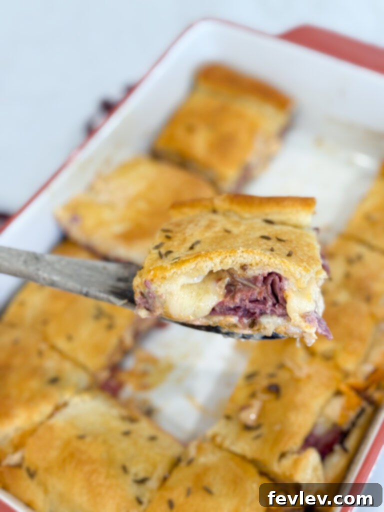 Pastrami Crescent Melt 11 A perfectly baked and sliced Pastrami Crescent Sandwich Bake, ready to serve.
