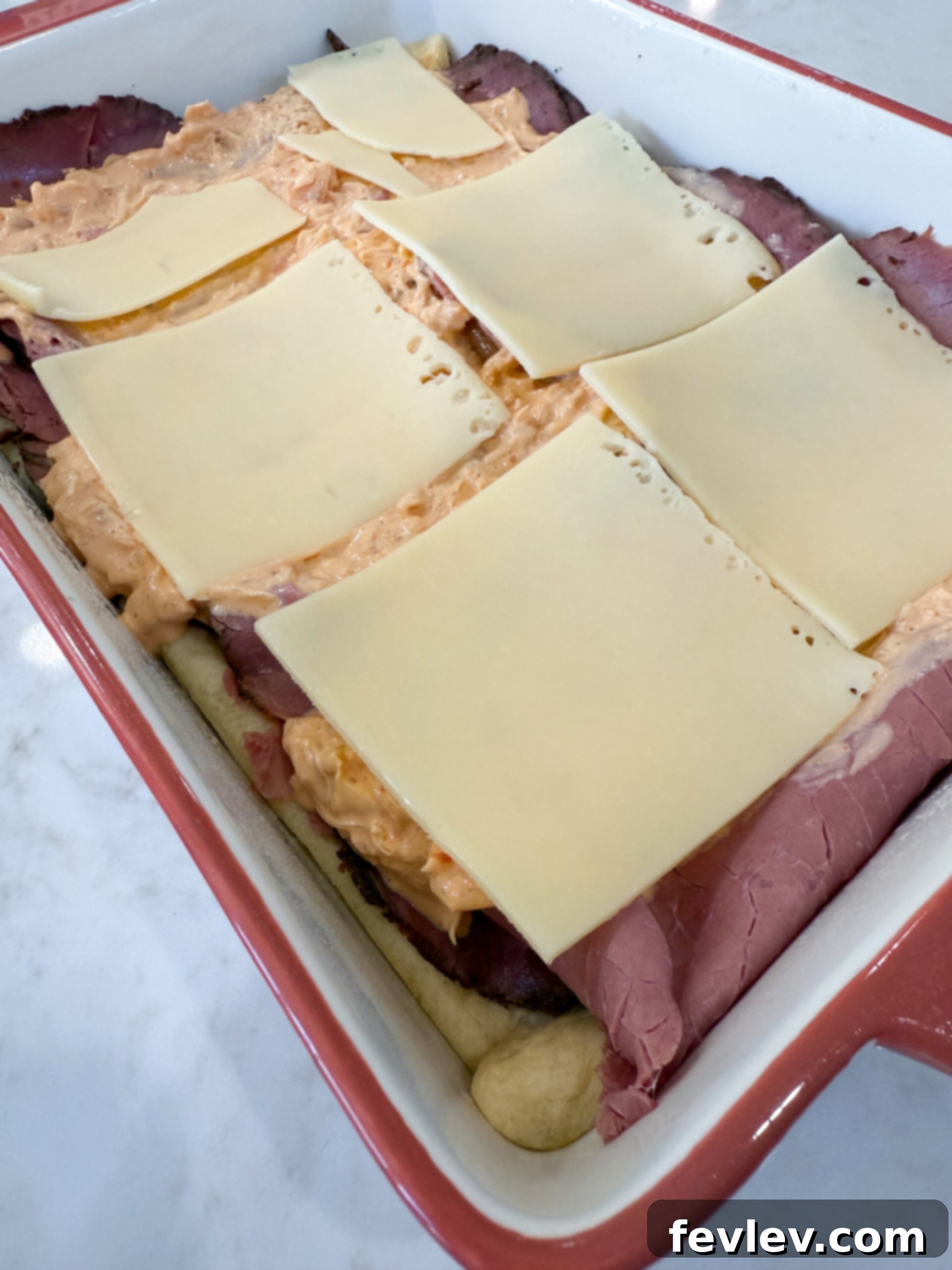 Pastrami Crescent Melt 8 Remaining Swiss cheese slices layered over the sauerkraut and dressing.