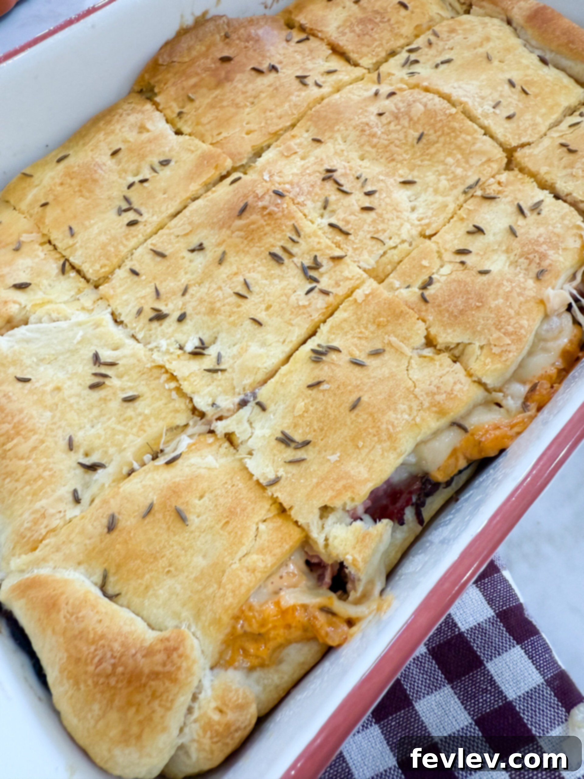 Pastrami Crescent Melt 10 Pastrami Crescent Sandwich Bake baking in the oven, golden brown.