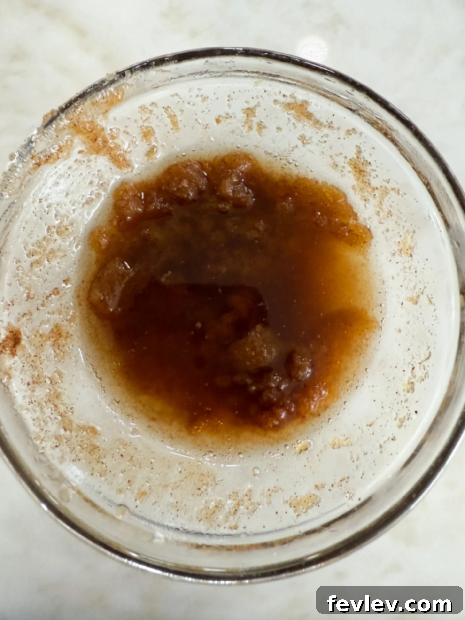 Melted butter, brown sugar, and cinnamon in a bowl for the donuts