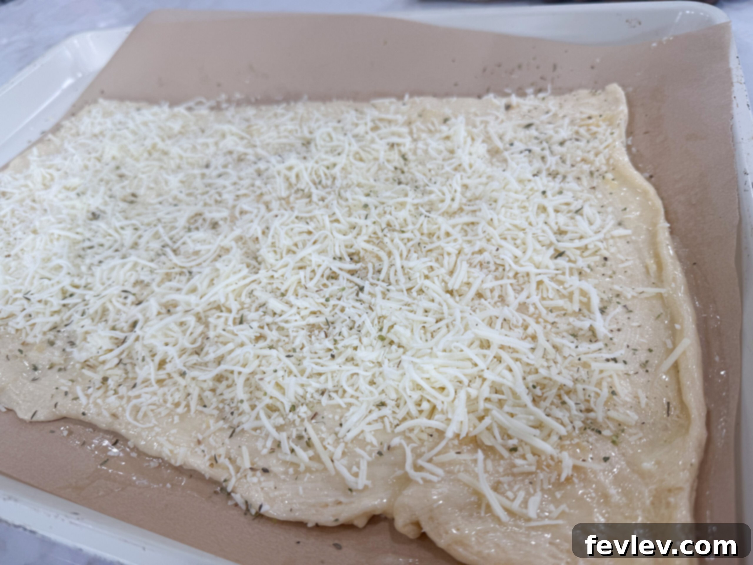 Pillowy Cheesy Garlic Crescent Bread 6 Sprinkling mozzarella and Parmesan cheese over dough