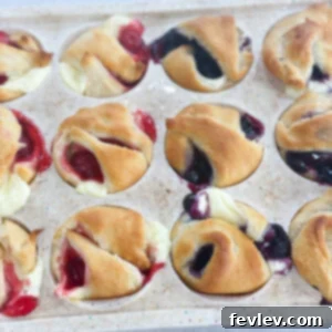 Golden mini cheesecake pies topped with blueberry filling, a perfect bite-sized dessert.