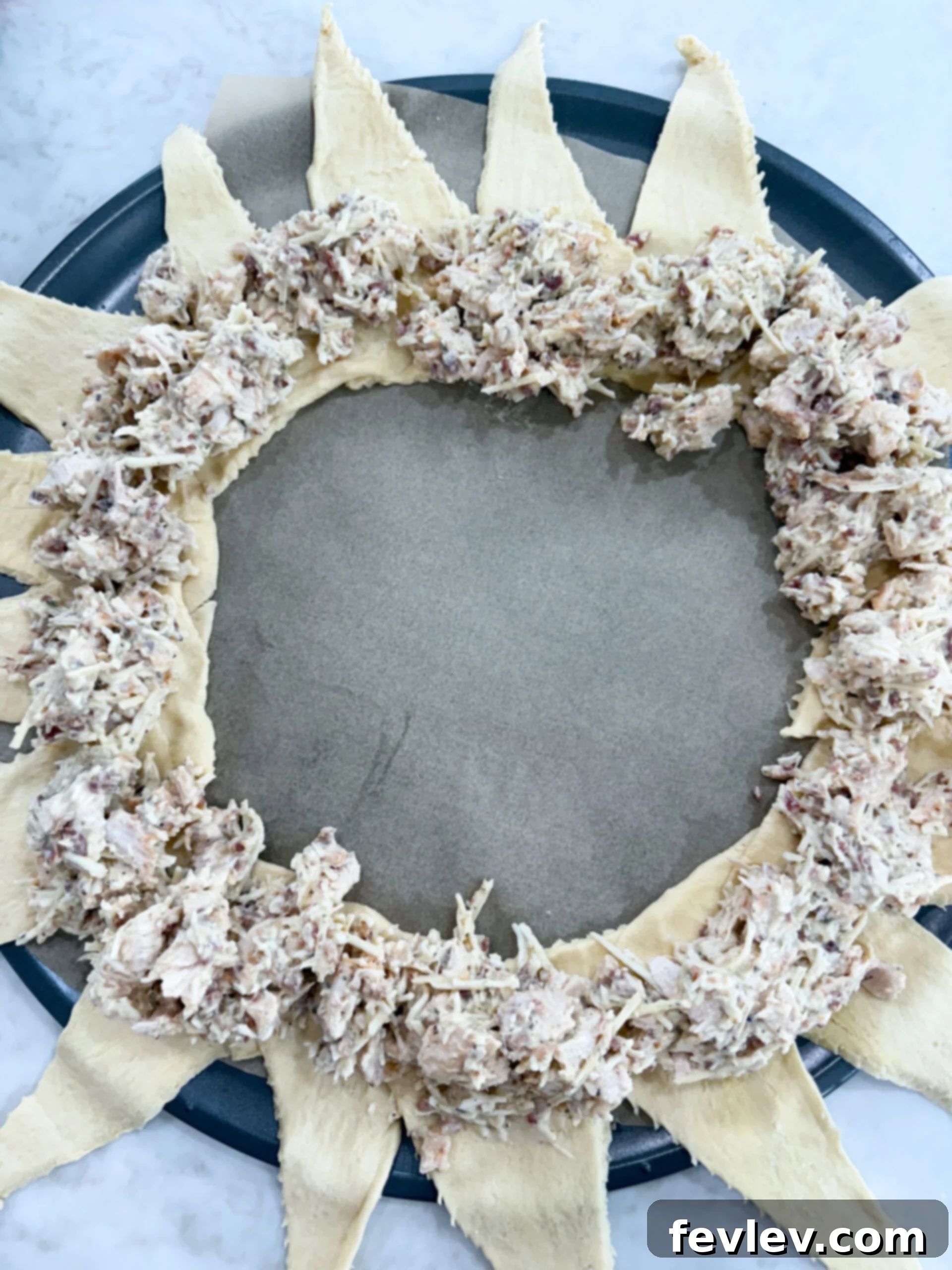 Golden Bacon Alfredo Bake 7 The chicken Alfredo and bacon filling, perfectly spooned and evenly distributed in a circular pattern over the overlapped wide ends of the crescent dough triangles.