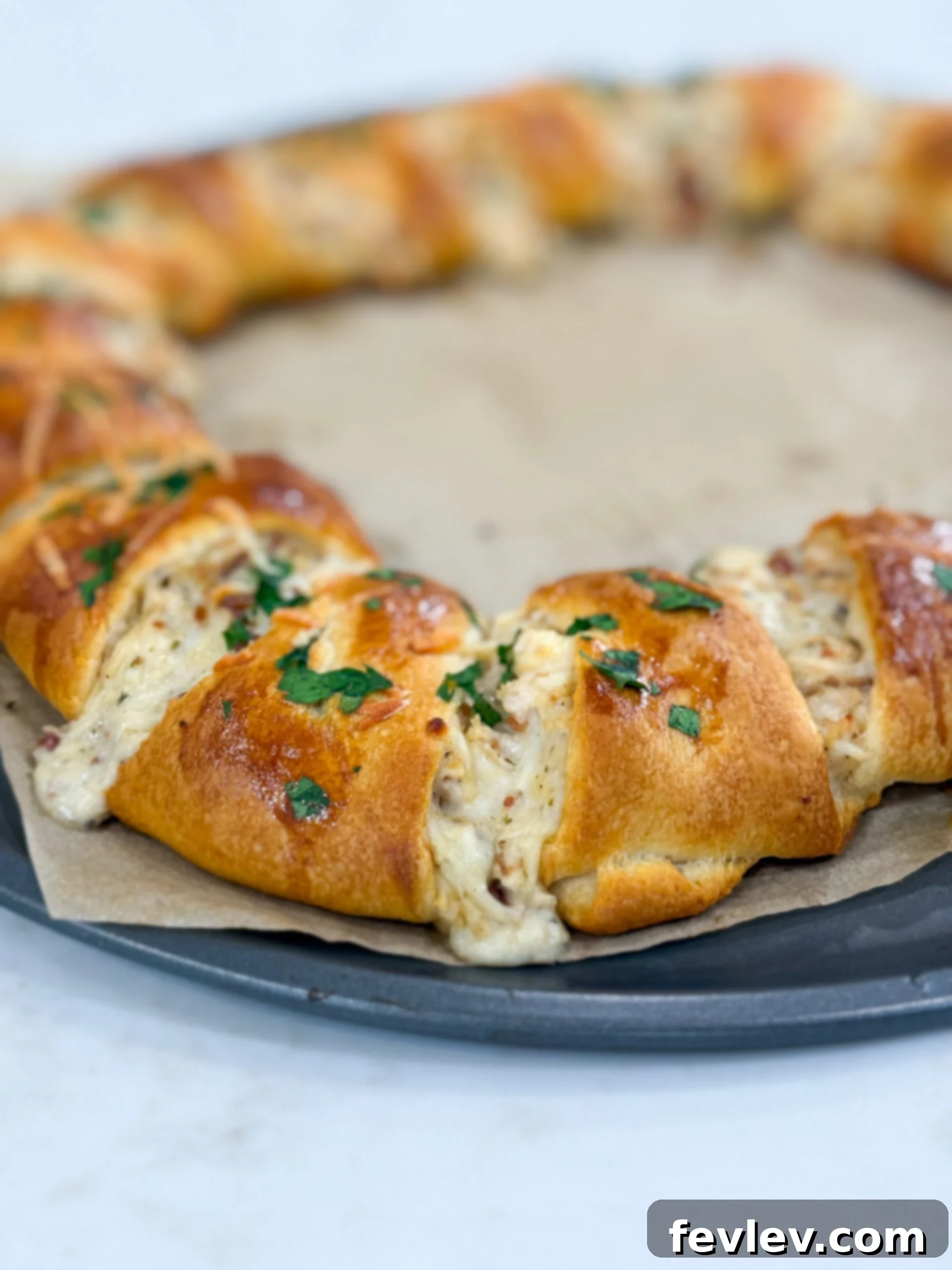Golden Bacon Alfredo Bake 8 The fully assembled Bacon Chicken Alfredo Crescent Ring, with the dough points folded over the filling and brushed with egg wash, ready to be baked to a golden perfection.