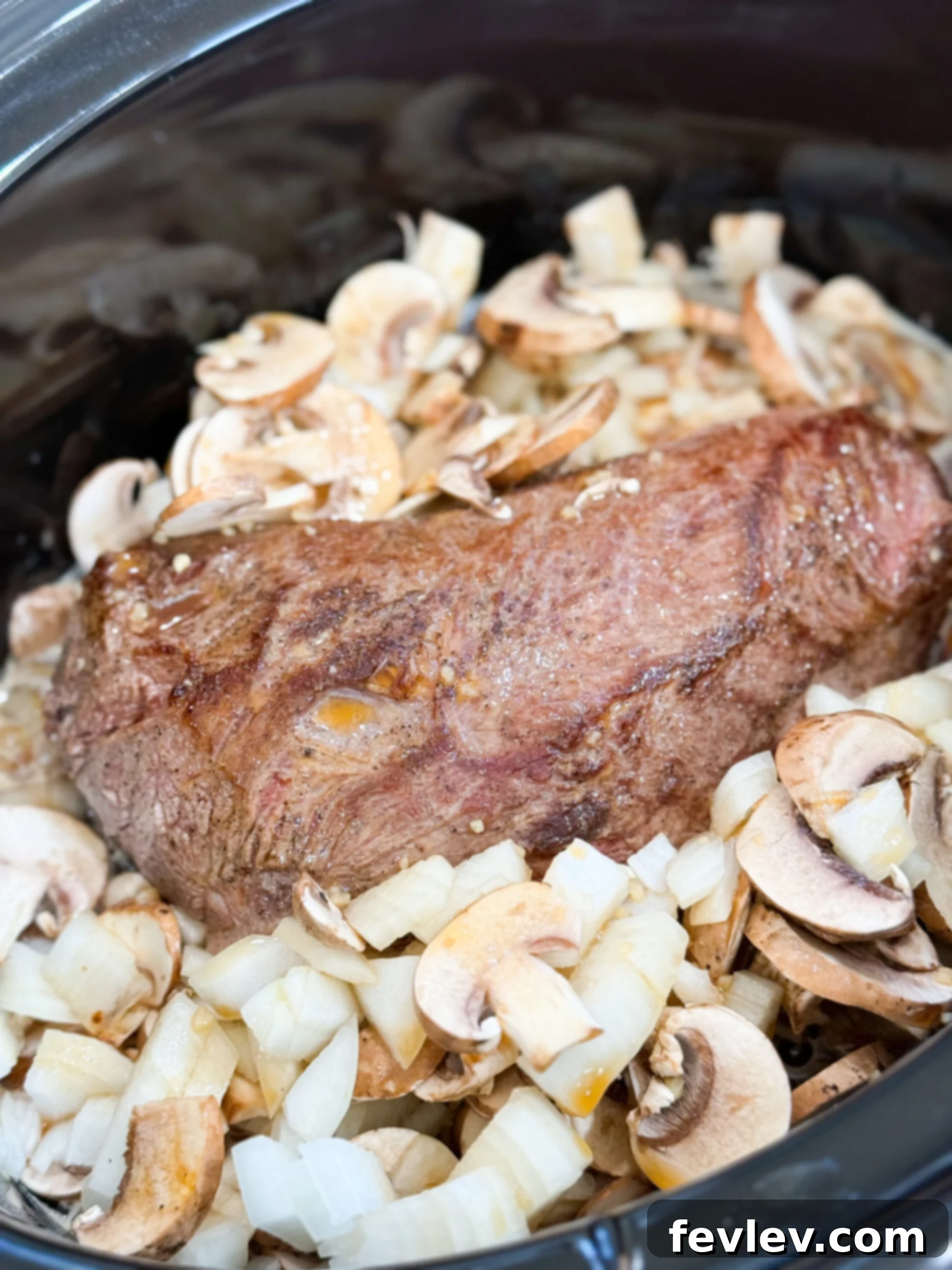 Tender & Creamy Slow Cooker Beef Stroganoff 8 Beef roast, sliced mushrooms, and diced onions in the slow cooker, ready for the sauce