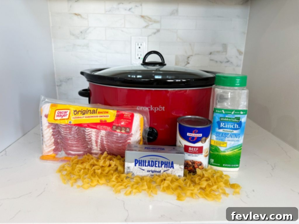 Ingredients for Slow Cooker Crack Chicken dinner, including chicken, broth, cream cheese, ranch seasoning, and cheese.