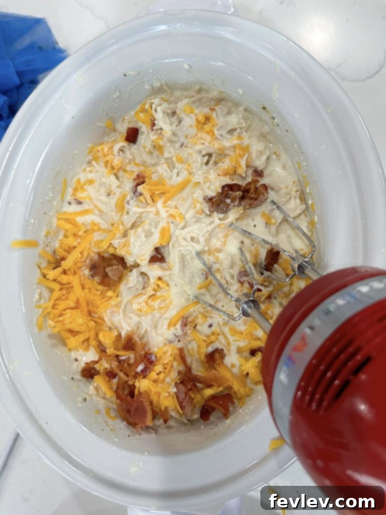 Preparing Slow cooker crack chicken dinner by adding ingredients to the cooker.