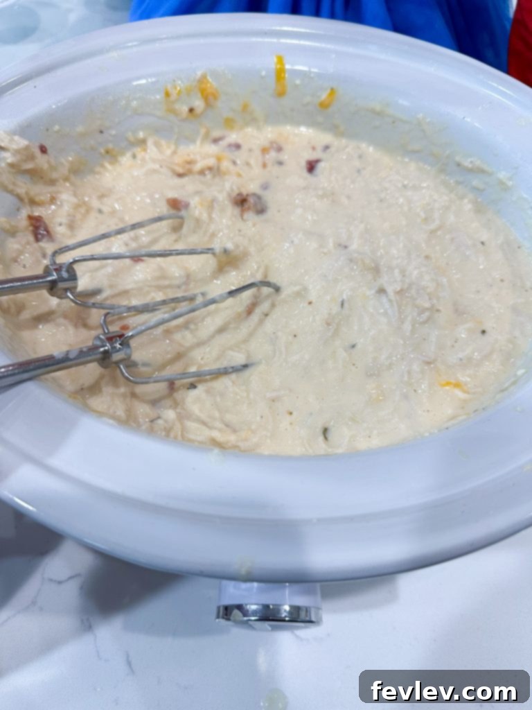 Slow cooker crack chicken dinner served with crumbled bacon and cheese.