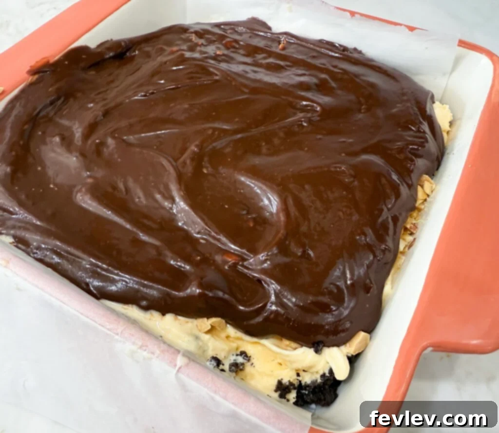 Spreading fudgy chocolate sauce evenly on the cake
