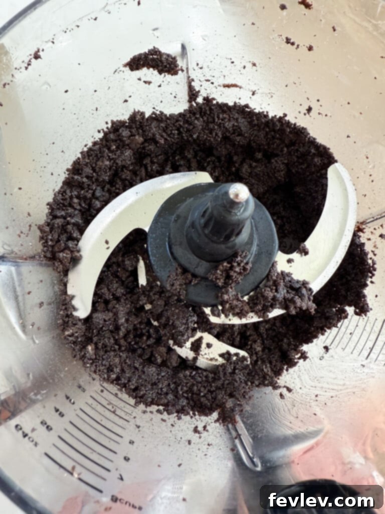 Mixed Oreos and butter forming the crust