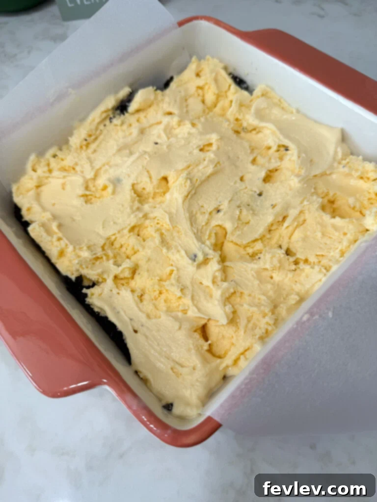 Spreading creamy ice cream onto the Oreo crust