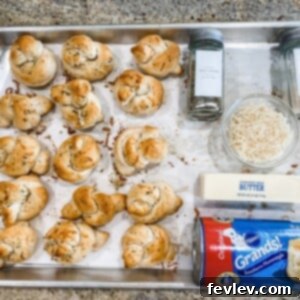 Garlicky Dough Twists 2 Delicious golden brown garlic knots brushed with butter and herbs, ready to serve on a rustic wooden board.