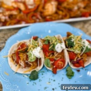 Sizzling Sheet Pan Chicken Fajitas with colorful bell peppers and onions, ready to be served with warm tortillas and fresh toppings.