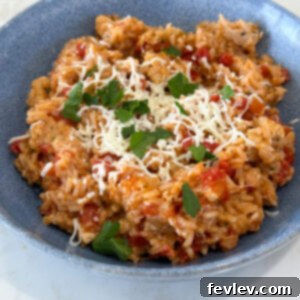 Cooked Caprese Chicken and Rice on a plate, garnished with fresh basil, ready to be served.