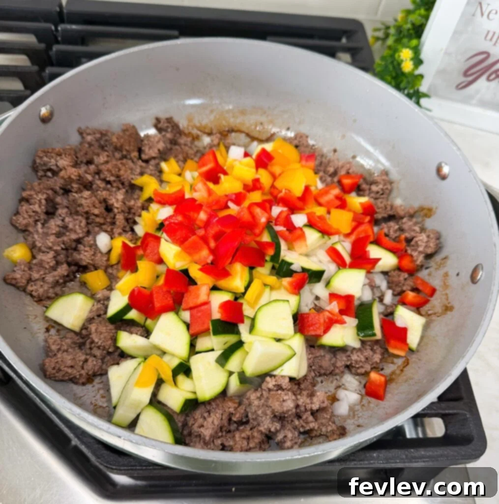 Quick Skillet Taco Dinner 3 Ground beef cooking in a large skillet for taco skillet recipe