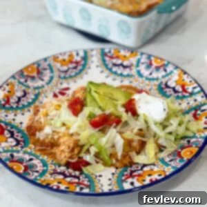 Red Chili Chicken Enchiladas 10 Pan of cheesy red chili chicken enchiladas topped with tomatoes, avocado, lettuce, and sour cream.