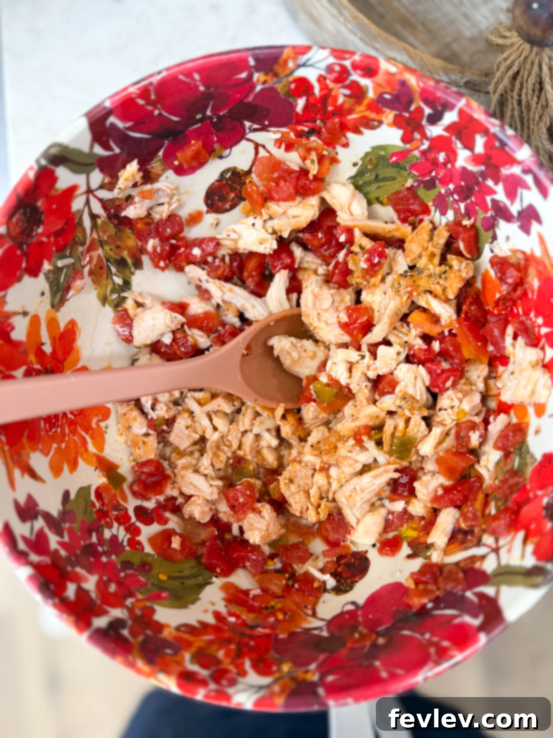 Red Chili Chicken Enchiladas 6 Mixing shredded chicken and Rotel in bowl