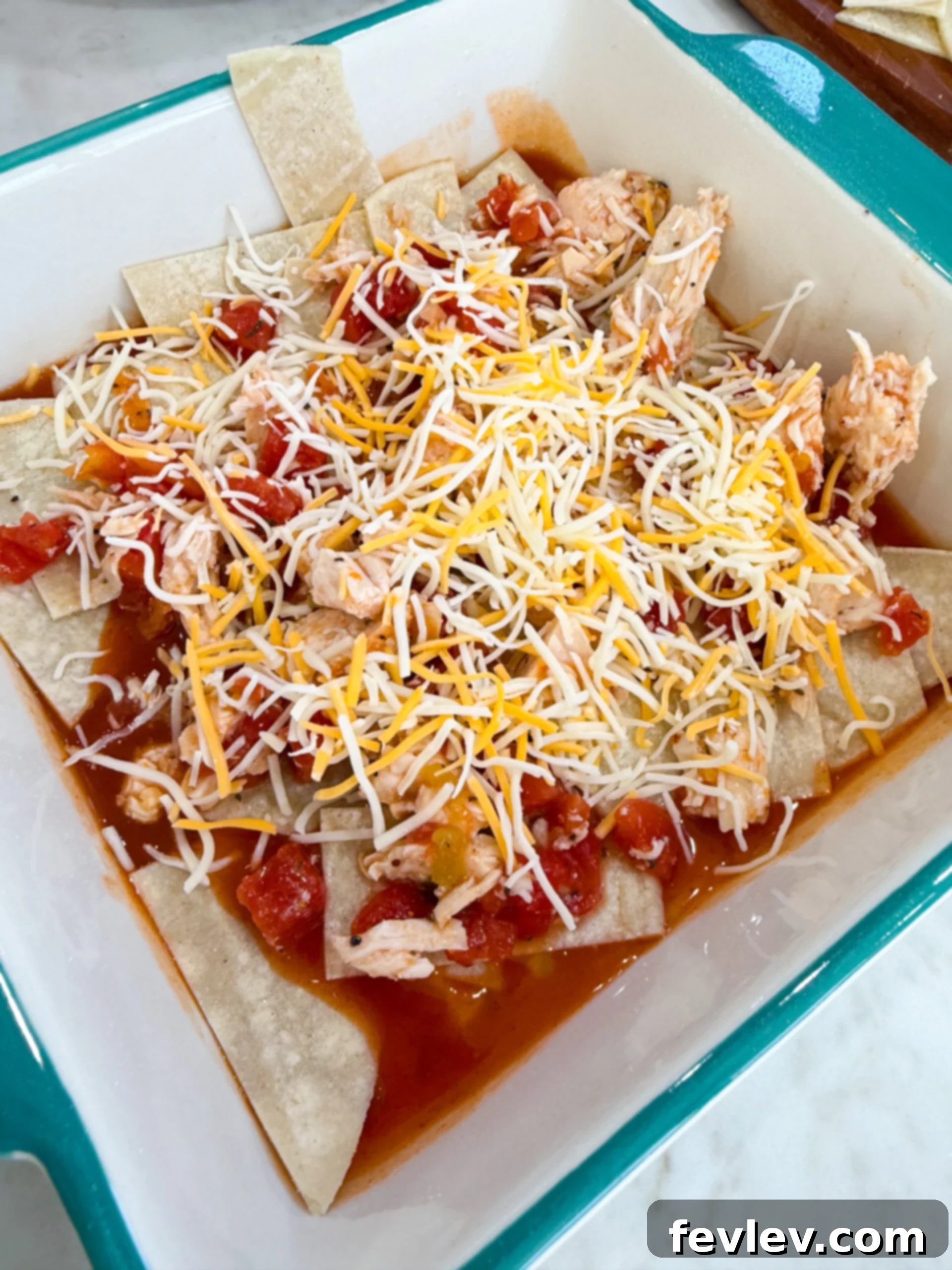 Red Chili Chicken Enchiladas 7 Layering red chili enchiladas before baking