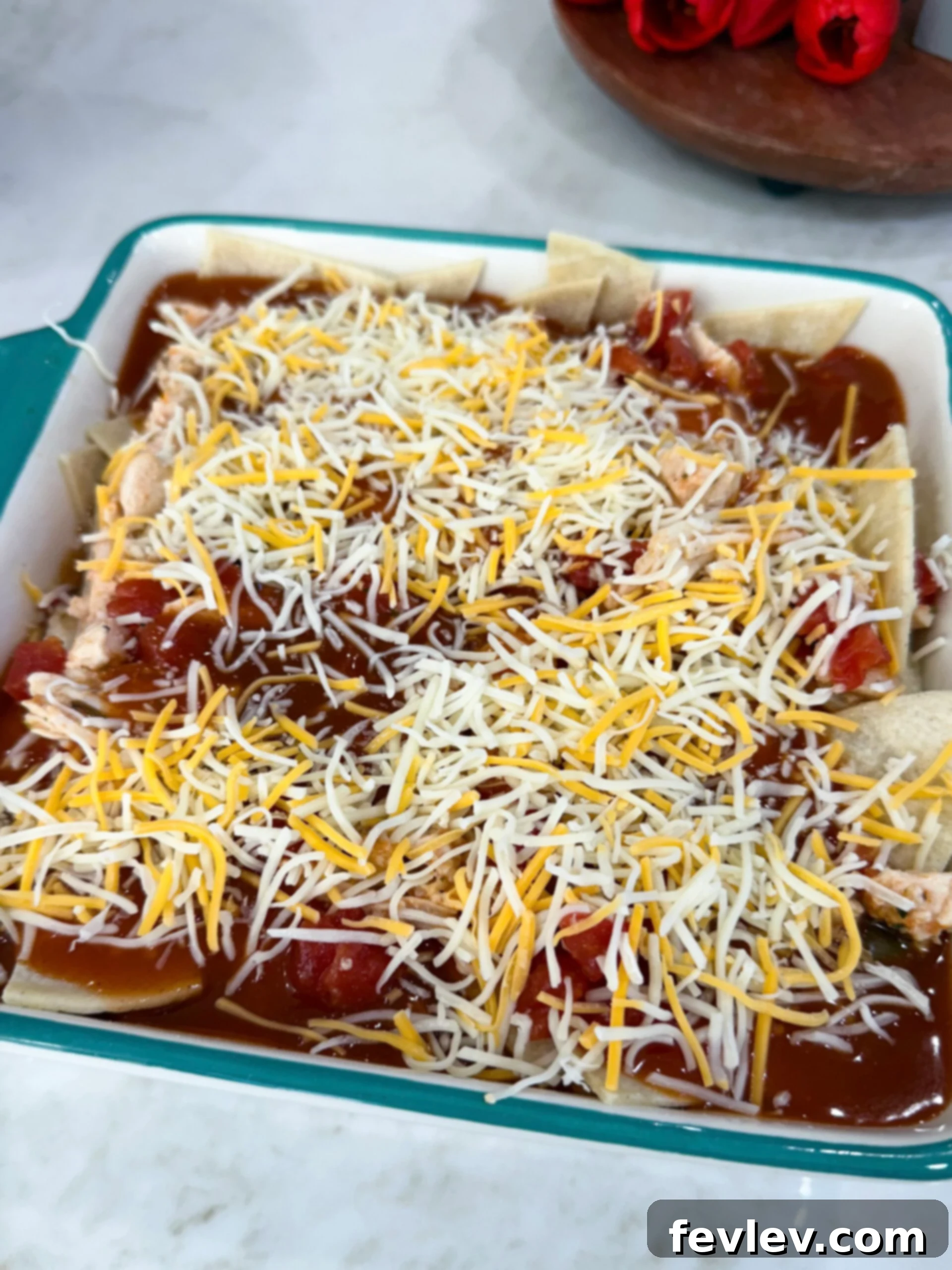 Red Chili Chicken Enchiladas 8 red chili enchiladas in the dish ready to be put into the oven