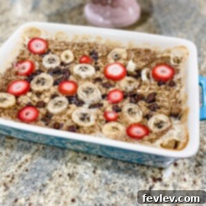 Deliciously golden Baked Oatmeal with fresh strawberries and bananas.