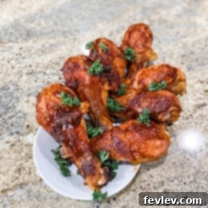 Deliciously sticky Sheet Pan BBQ Drumsticks with a rich, smoky glaze, garnished and ready to serve.