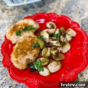 Delicious Sheet Pan Crusted Pork Chops with Roasted Brussel Sprouts, ready to eat.