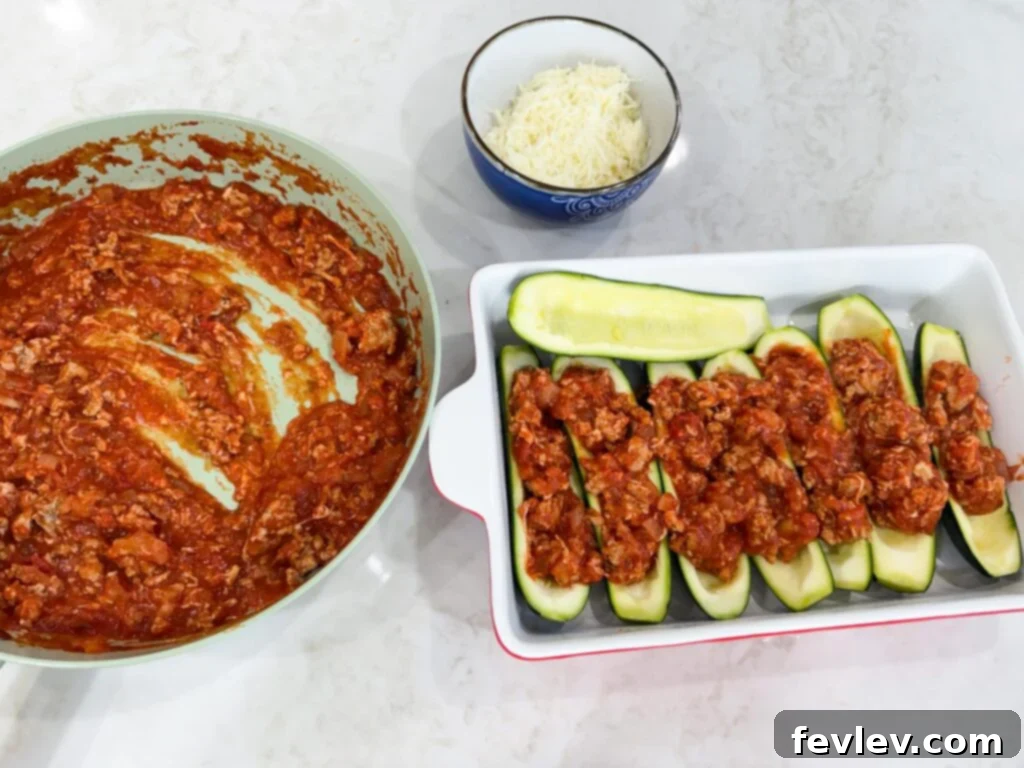 loading zucchini boats with turkey mixture