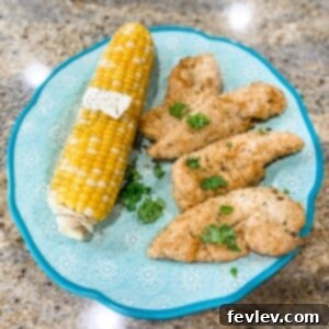 Crispy Baked Chicken Tenders on a white plate with dipping sauce