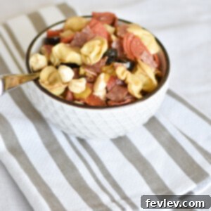 Delicious Antipasto Salad with cheese tortellini, pepperoni, salami, mozzarella, and pepperoncini